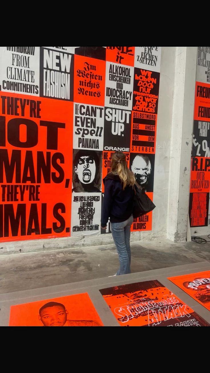 Wall covered in a grid of red and black type posters