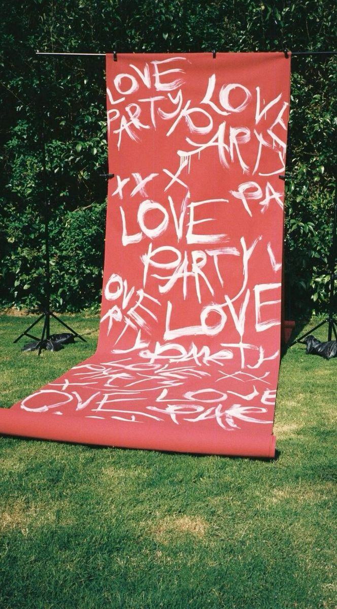 Red paper roll painted with white brush lettering outdoors
