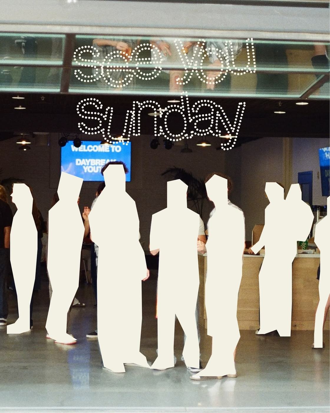 Life-size cream figure cutouts in a church lobby with dotted lettering